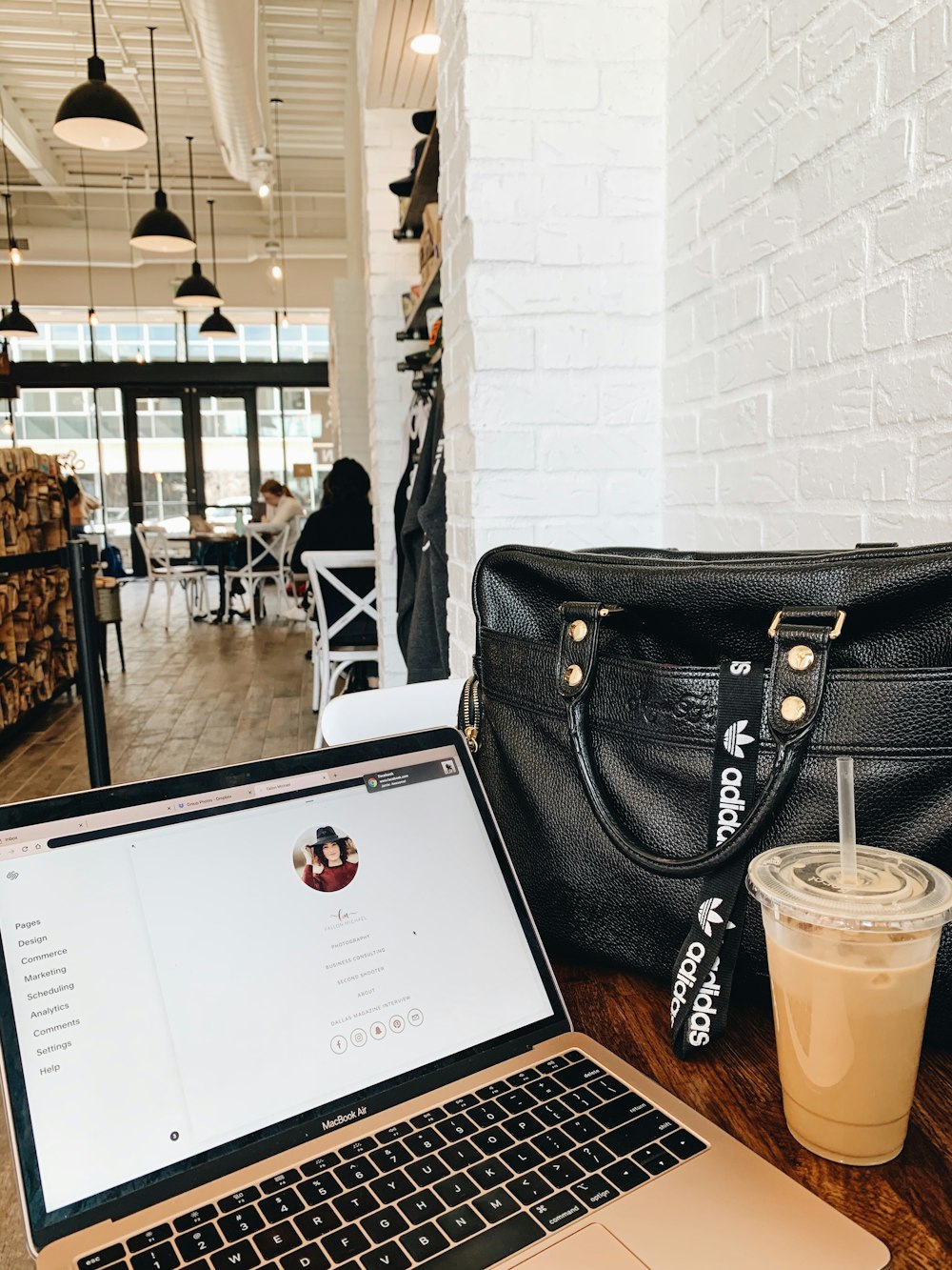 black leather handbag on brown wooden table