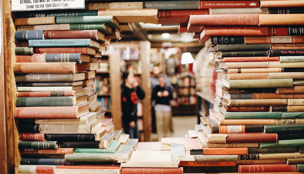 books on brown wooden shelf