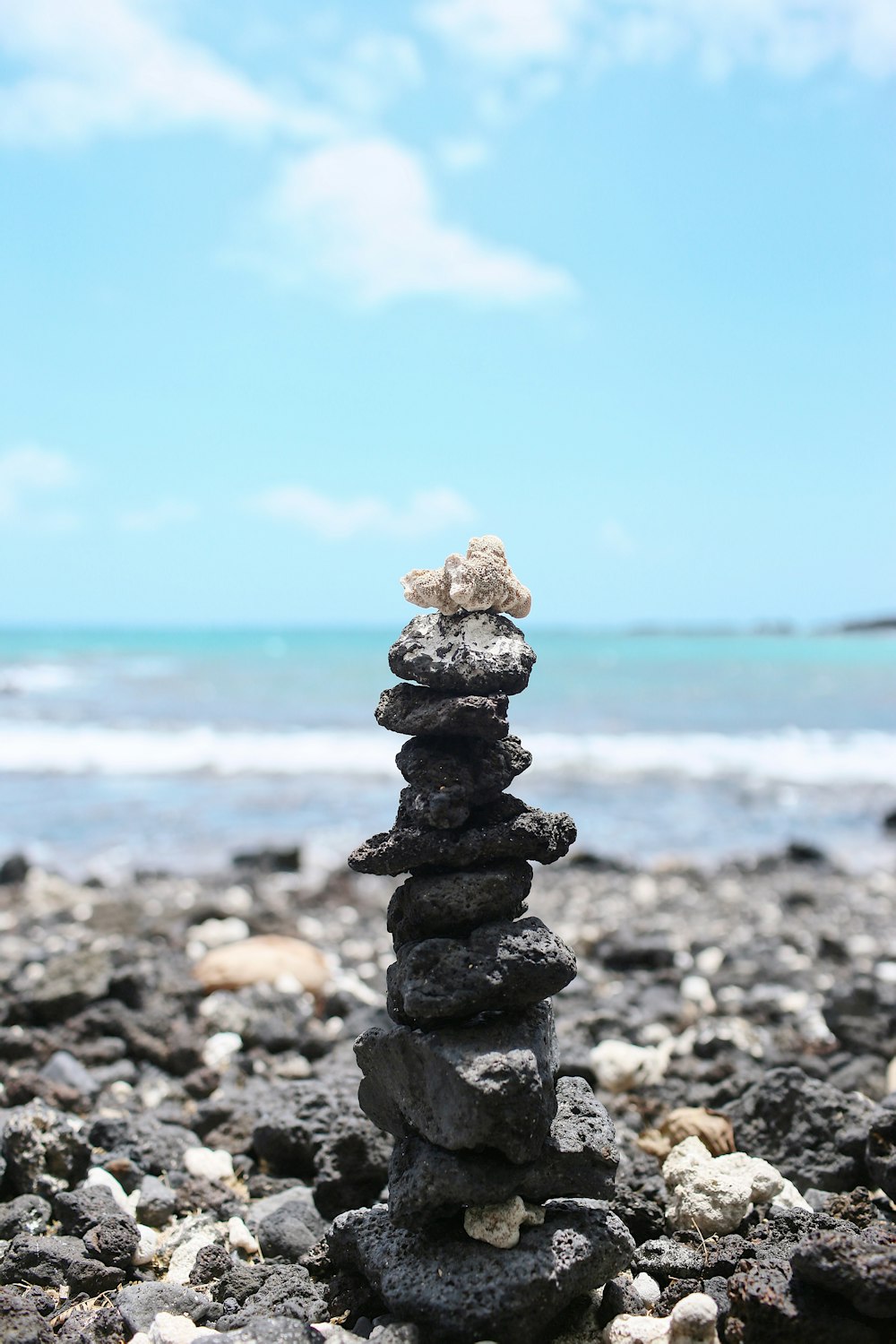 black and gray stone near body of water during daytime