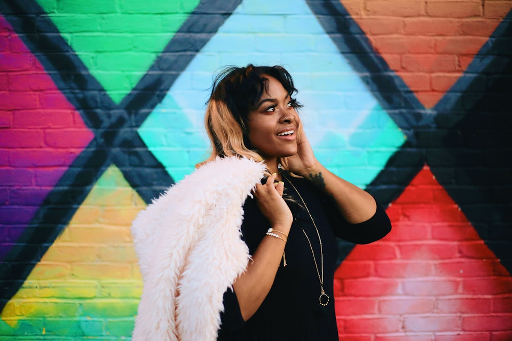 woman in black tank top wearing white fur coat