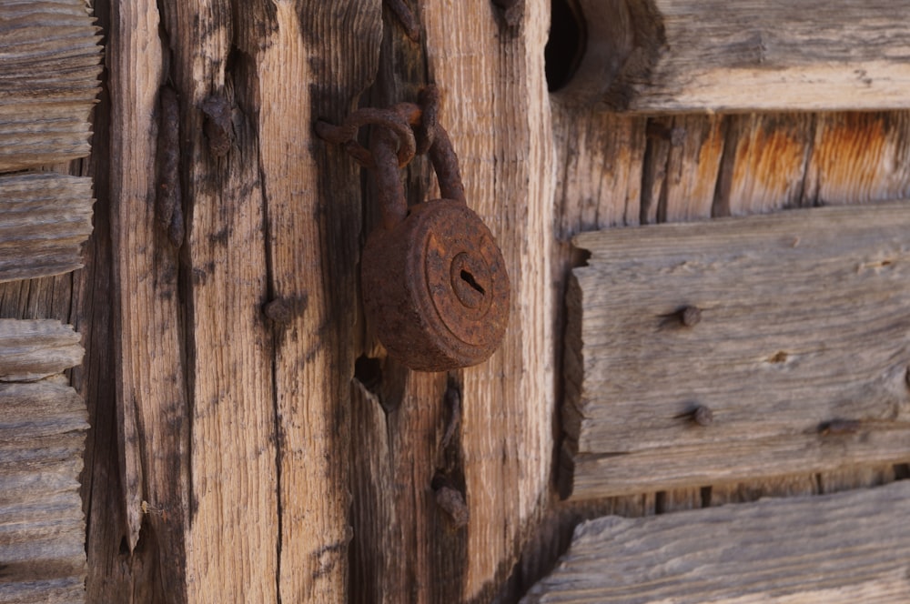 brown wooden door with padlock