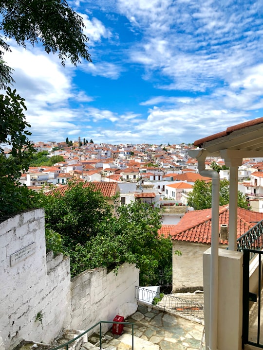 white and brown concrete houses under blue sky during daytime in Skíathos Greece