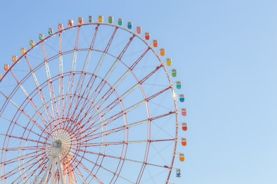 white and red ferris wheel in Giant Sky Wheel in Palette Town Japan