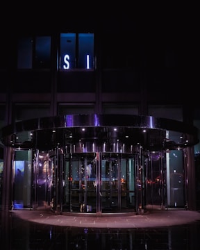 Night view of a building entrance illuminated with safety doors from Metro Door Solutions.