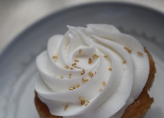 white icing covered cake on white ceramic plate