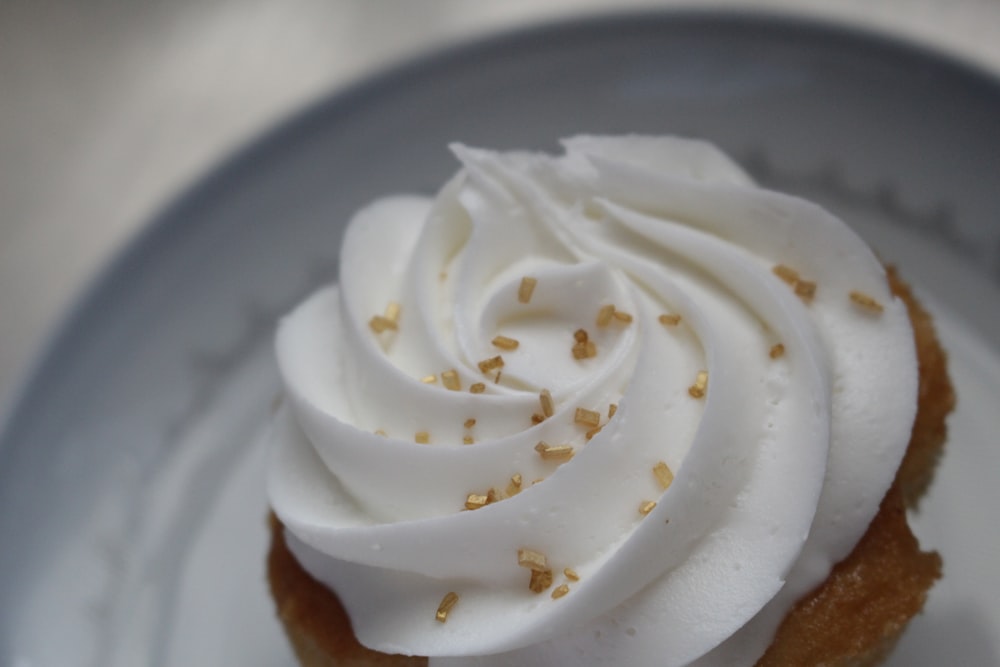 white icing covered cake on white ceramic plate