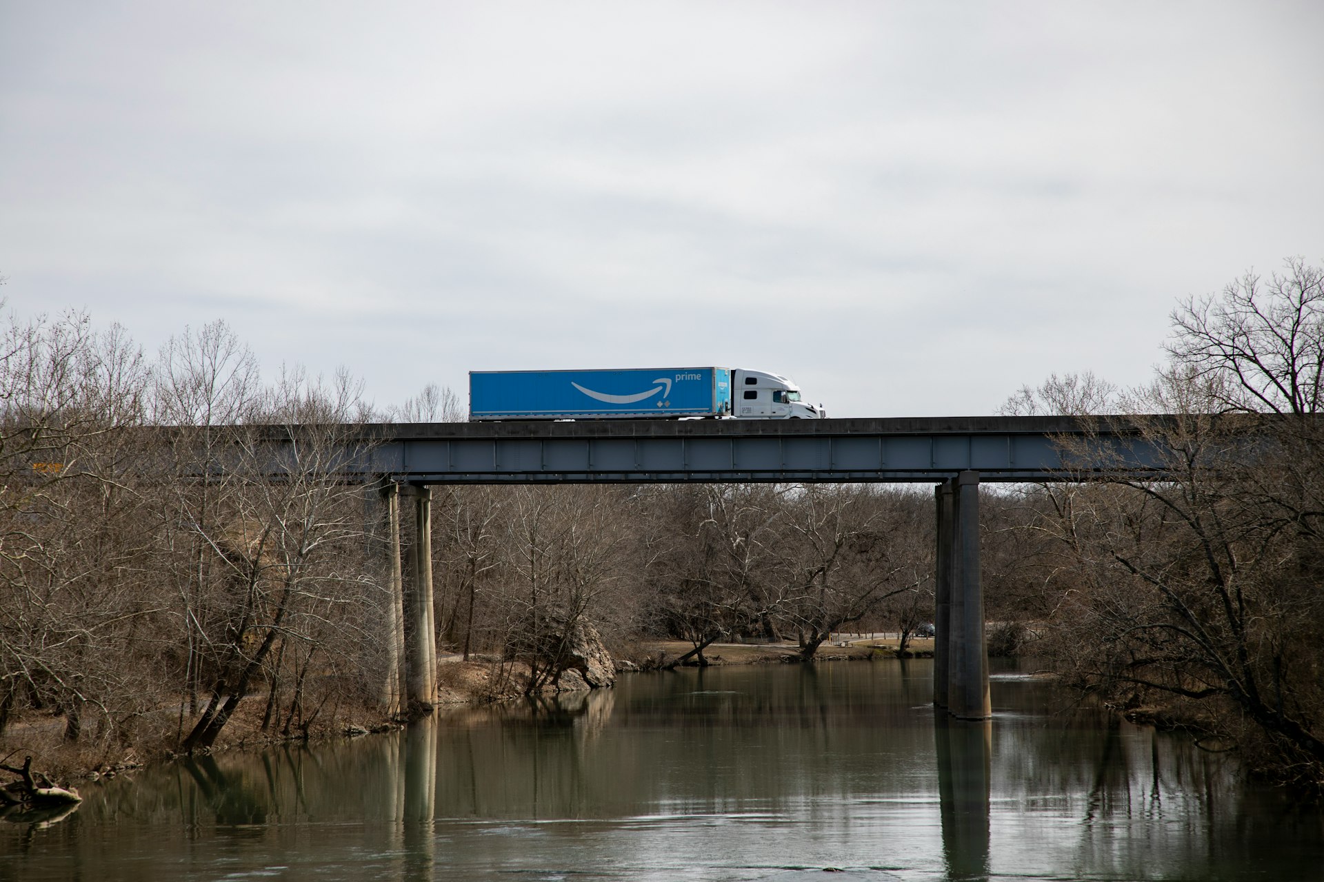 An Amazon Prime semitruck atop a bridge, presumably delivering goods during COVID-19.