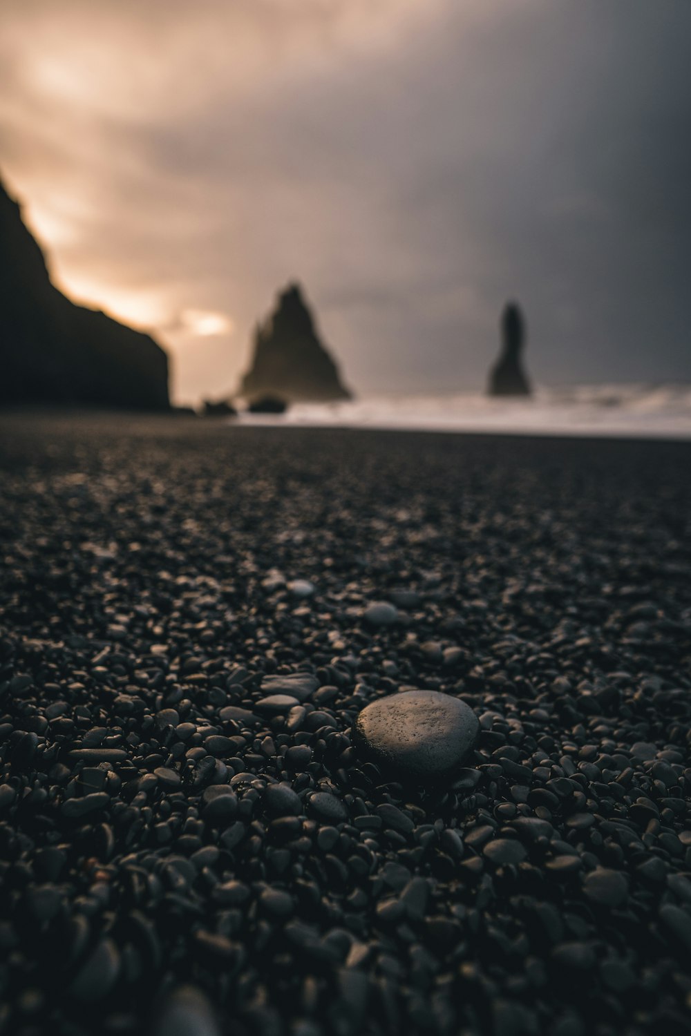 gray stone on black sand during daytime