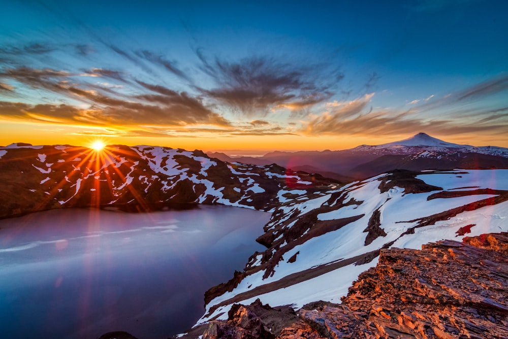 snow covered mountains during sunset