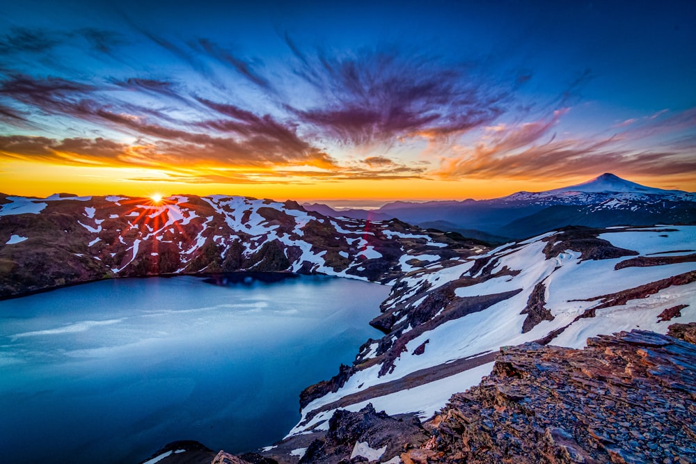 snow covered mountain during sunset