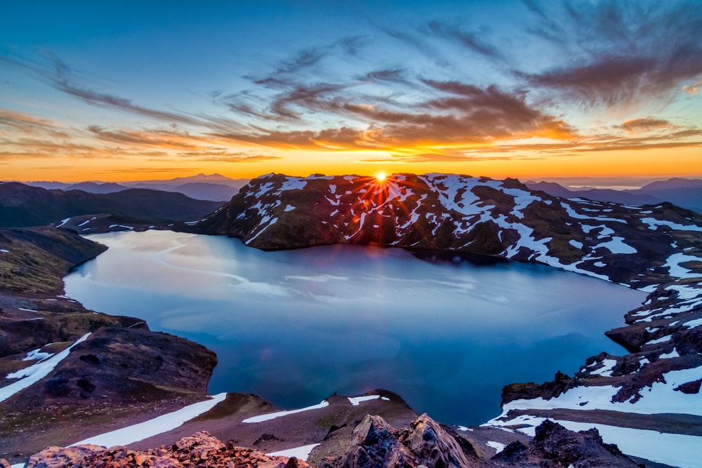 snow covered mountain during sunset