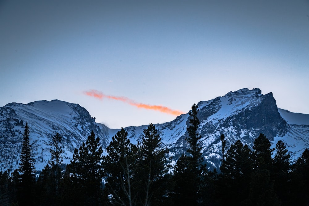 snow covered mountain during sunset