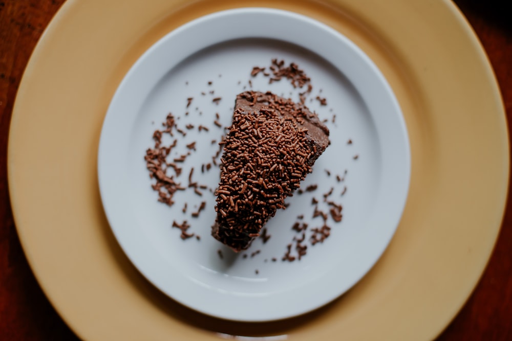 brown and black beads on white ceramic plate