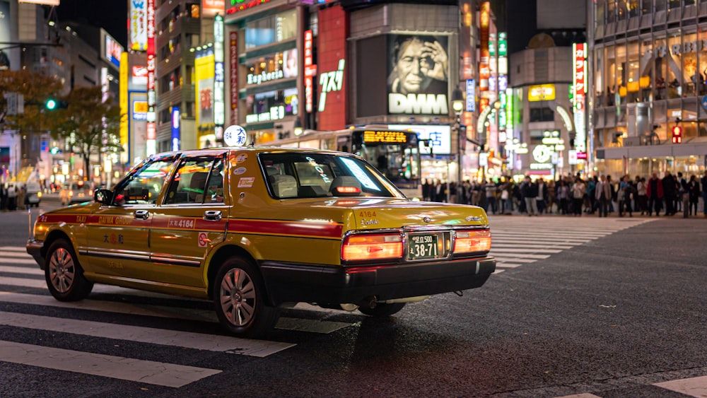 yellow sedan on the street during daytime