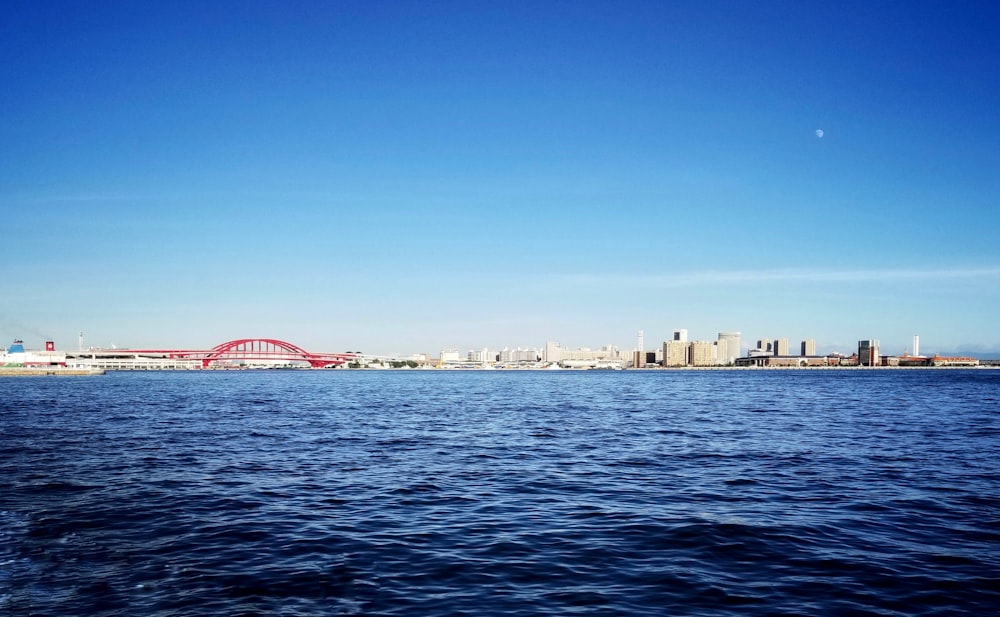 body of water near city buildings during daytime