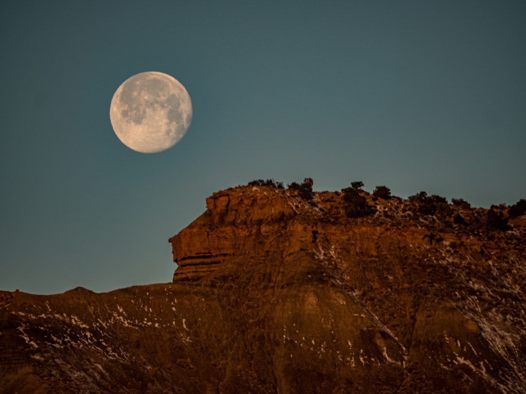 brown rocky mountain under full moon