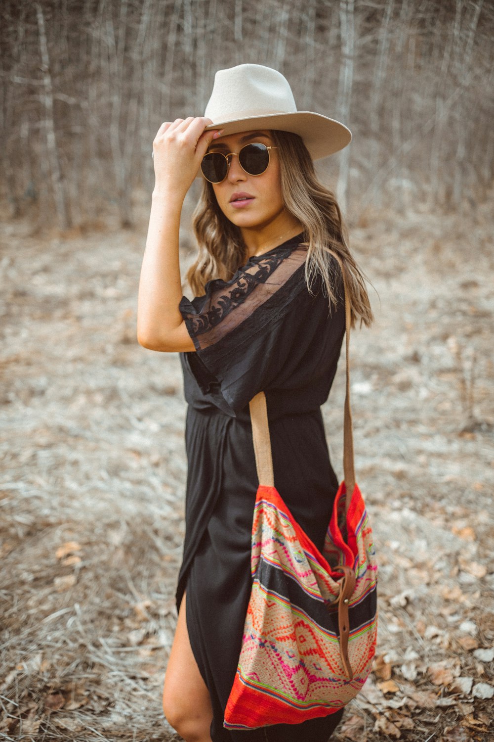 woman in black and red dress wearing brown sun hat