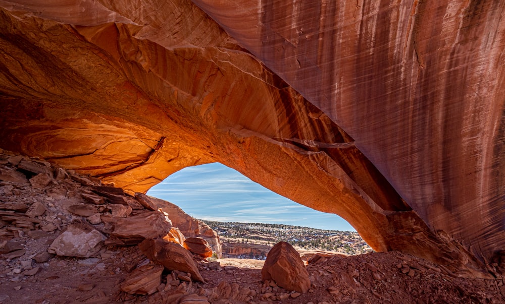 brown rock formation near body of water during daytime