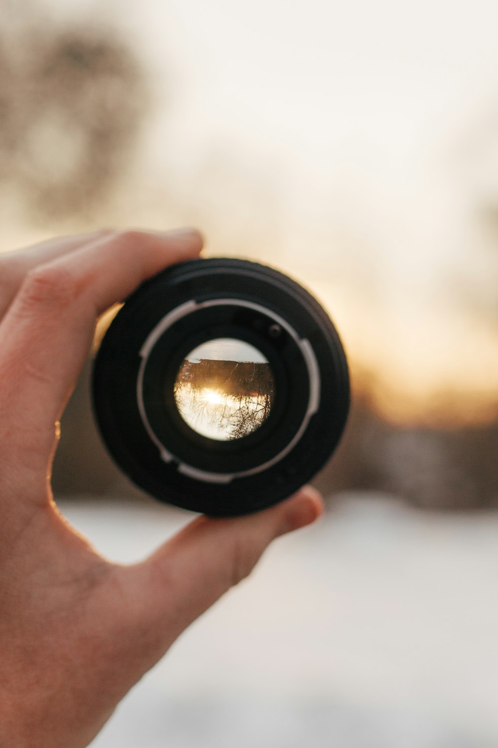 person holding black camera lens