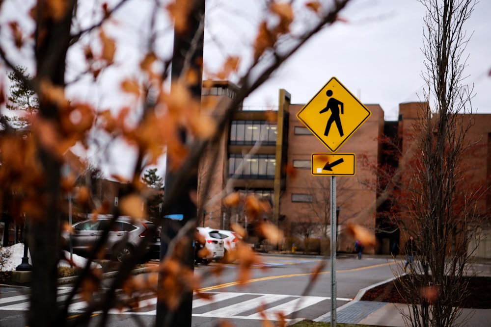 white and black pedestrian crossing sign