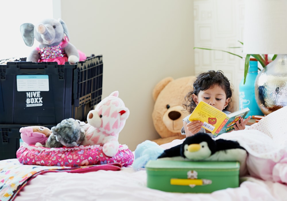 girl in pink and white shirt holding yellow book