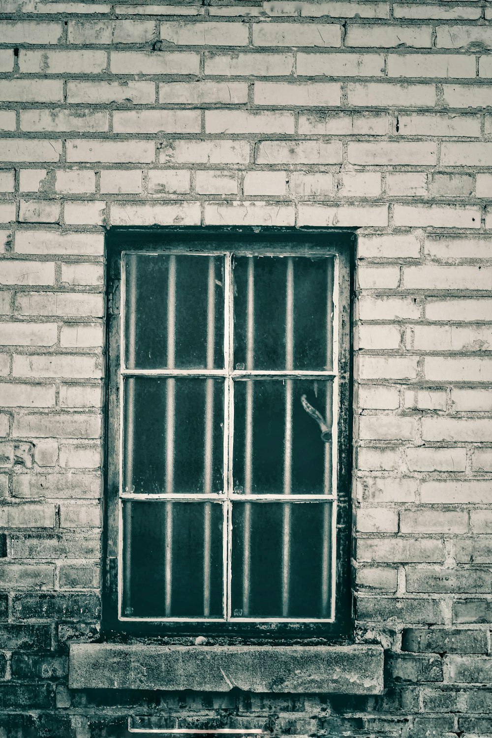 black wooden door on gray brick wall