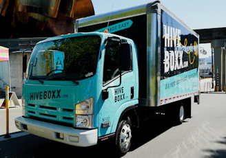 blue and white truck on road during daytime