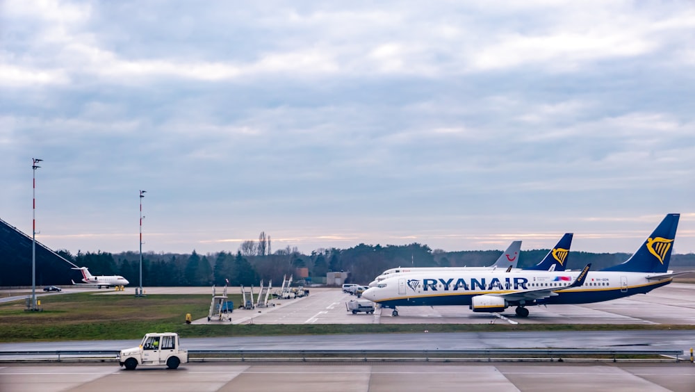 white and red passenger plane on airport during daytime