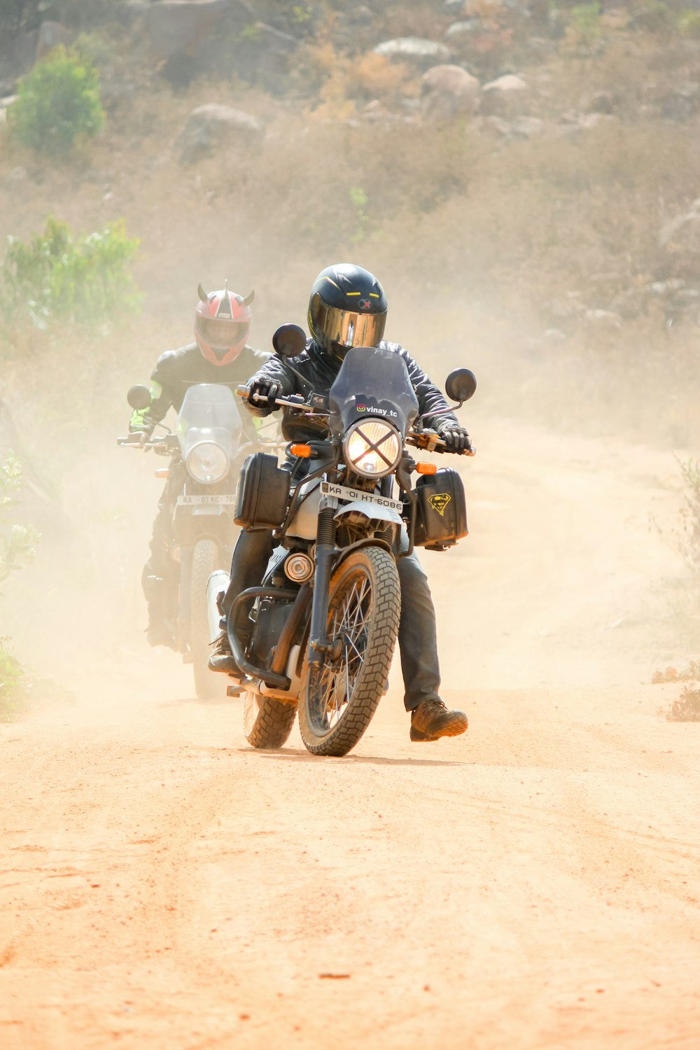 man riding motorcycle on dirt road during daytime