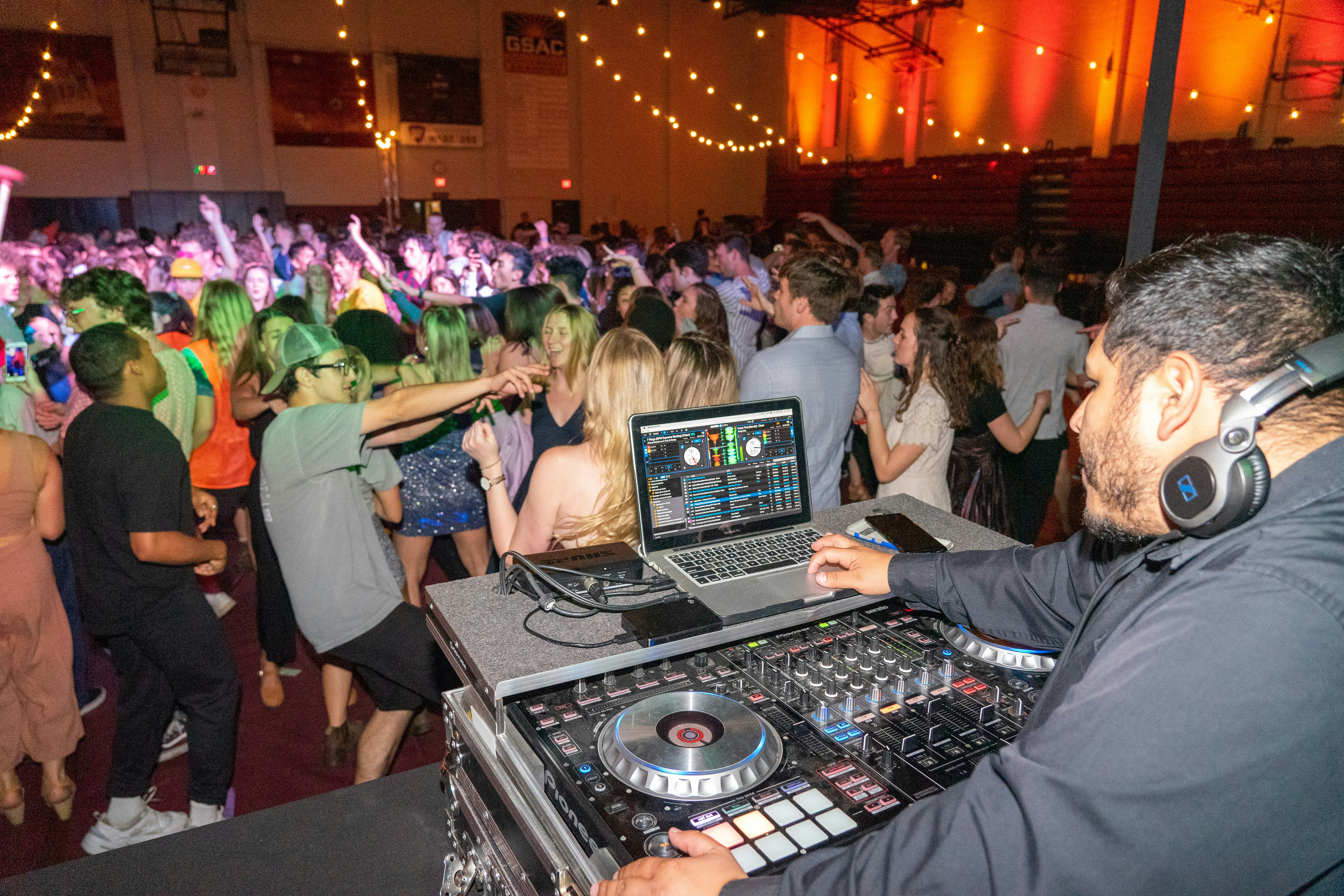 people sitting on chair in front of dj controller