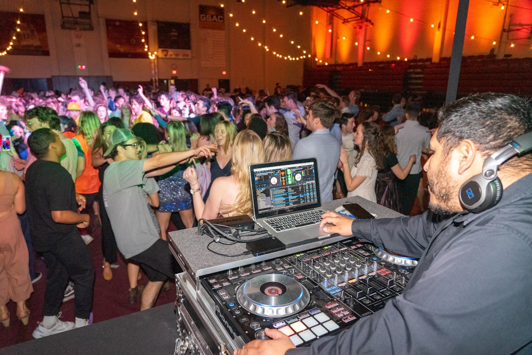 people sitting on chair in front of dj controller