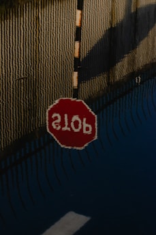stop sign on brown wall
