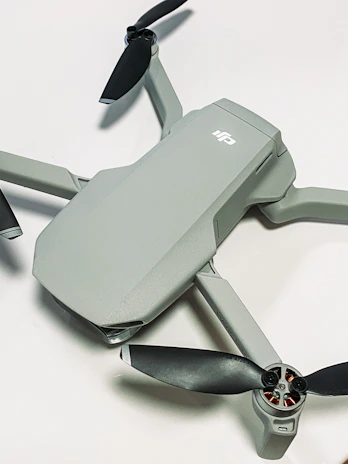 A dynamic FPV drone soaring smoothly through a modern hotel lobby, showcasing its sleek design.