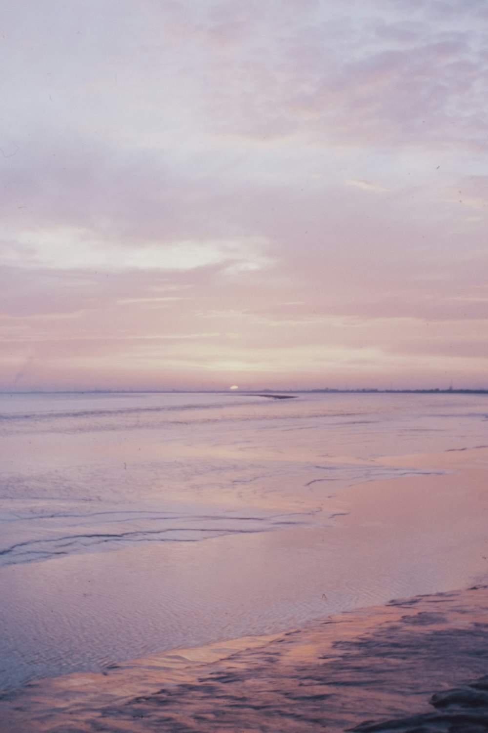 body of water under cloudy sky during daytime