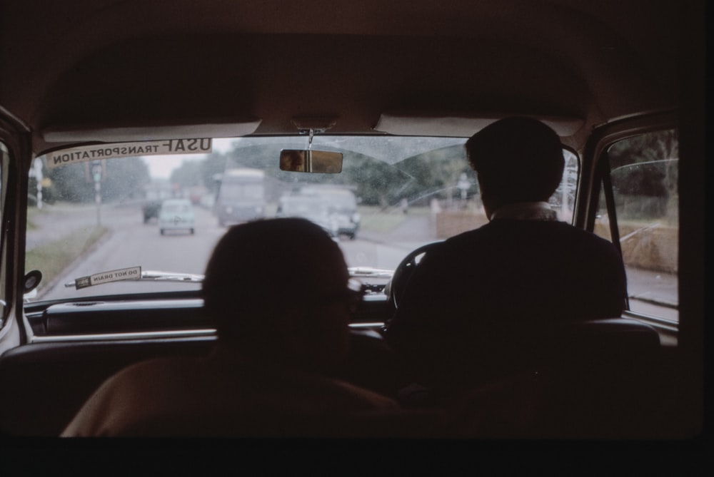 man in black jacket driving car during daytime