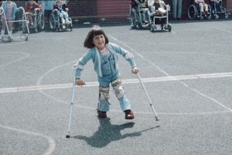 girl in blue and white striped long sleeve shirt and blue denim jeans holding walking stick