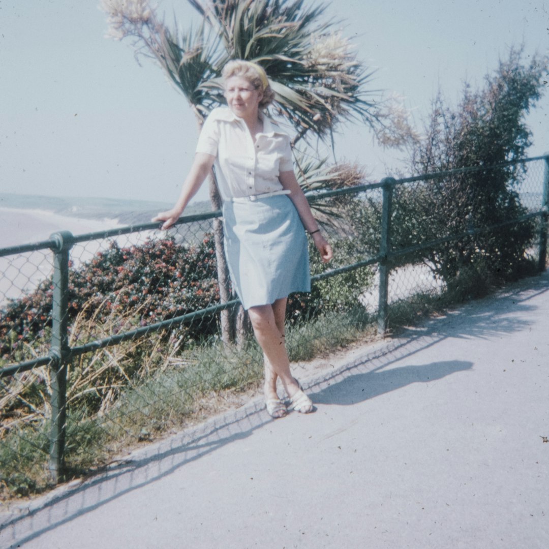 woman in white dress standing on gray concrete road during daytime