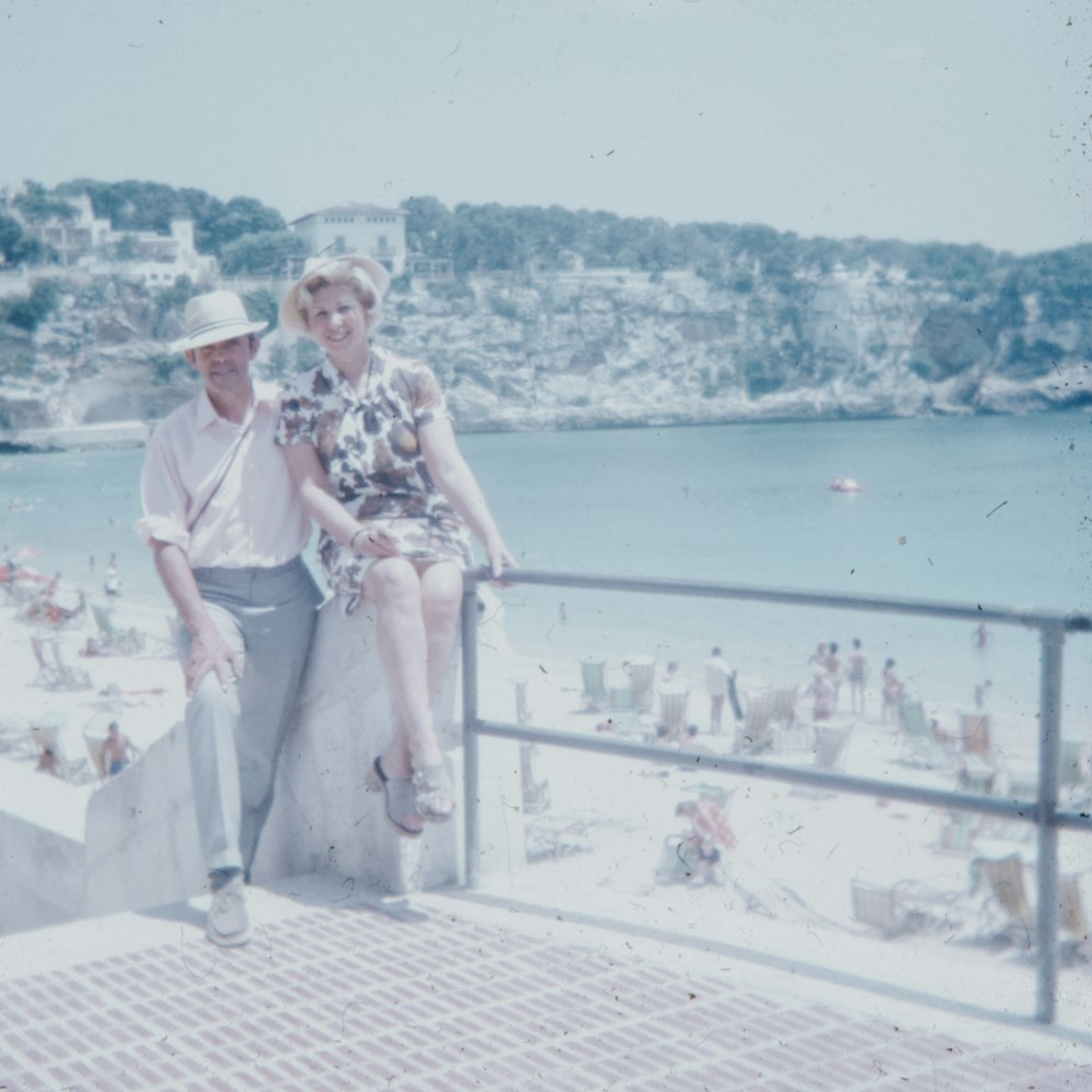man and woman sitting on white concrete stairs