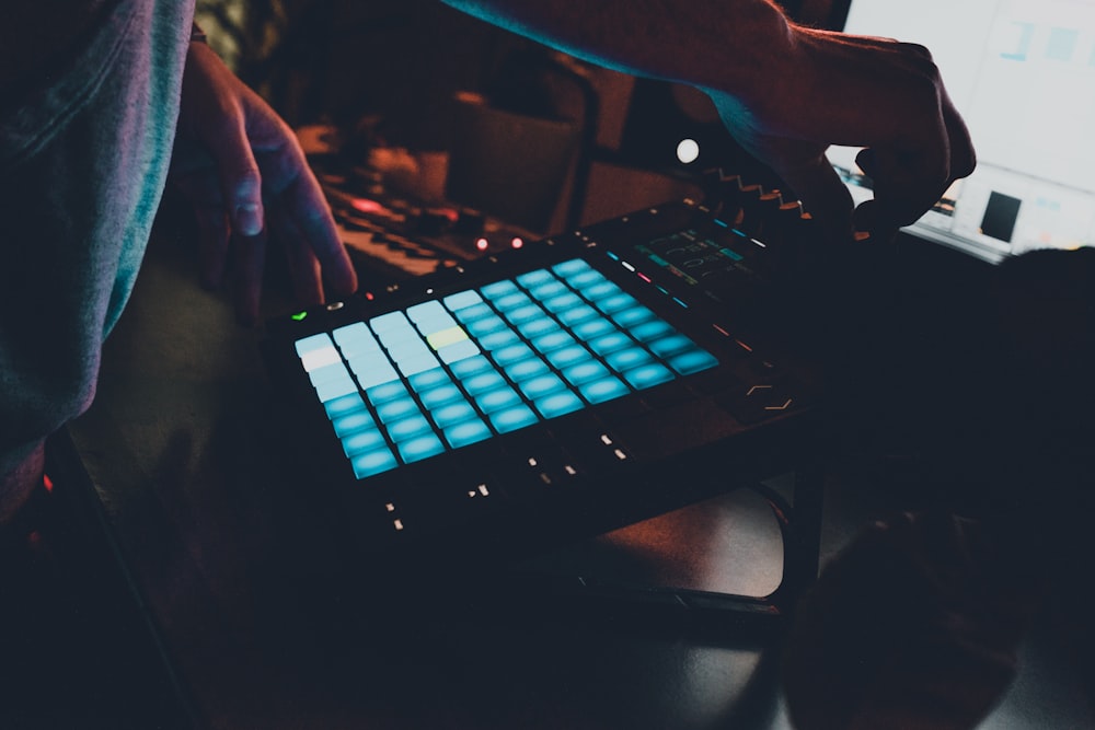 person playing black and white computer keyboard