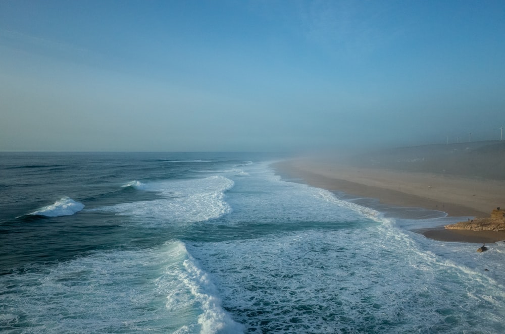 blue ocean water under blue sky during daytime