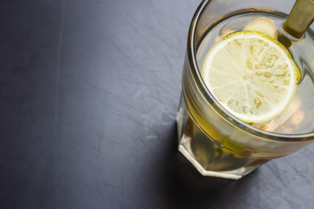 clear drinking glass with yellow liquid