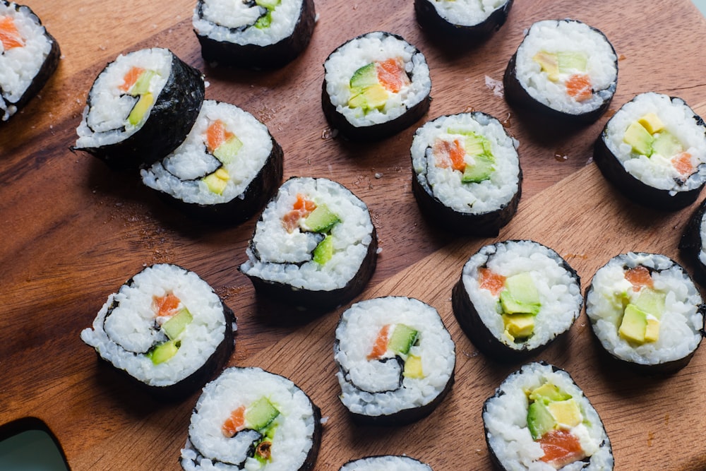 sushi rolls on brown wooden table
