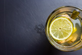 Close-up of a vibrant cup filled with freshly squeezed lemonadez, condensation dripping down the sides.