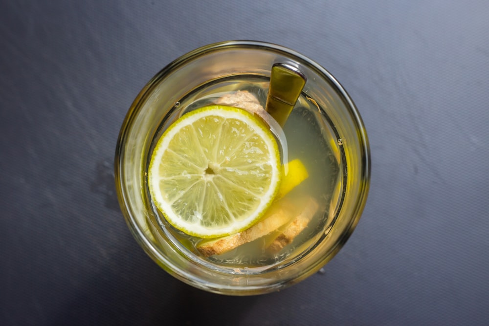 sliced lemon in clear glass cup