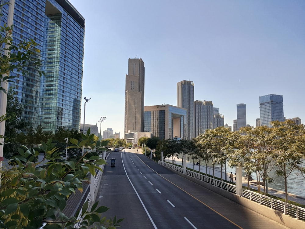 gray concrete road between high rise buildings during daytime