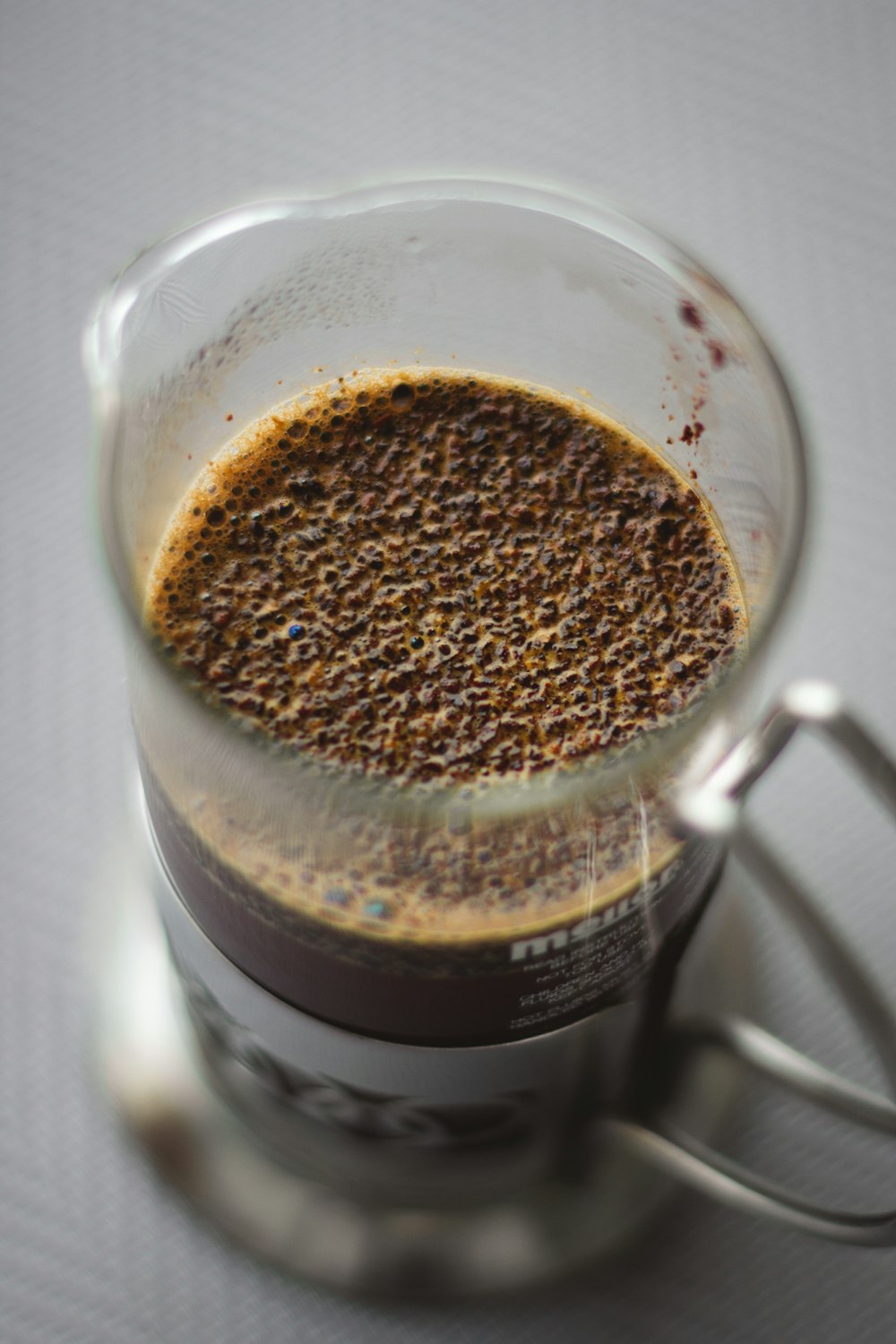 clear glass mug with brown liquid