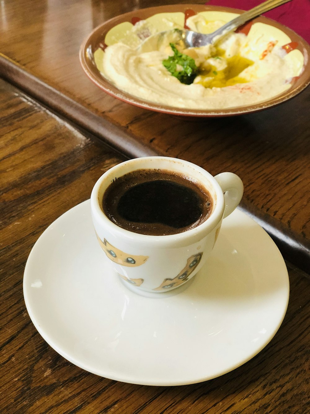 white ceramic cup on white ceramic saucer