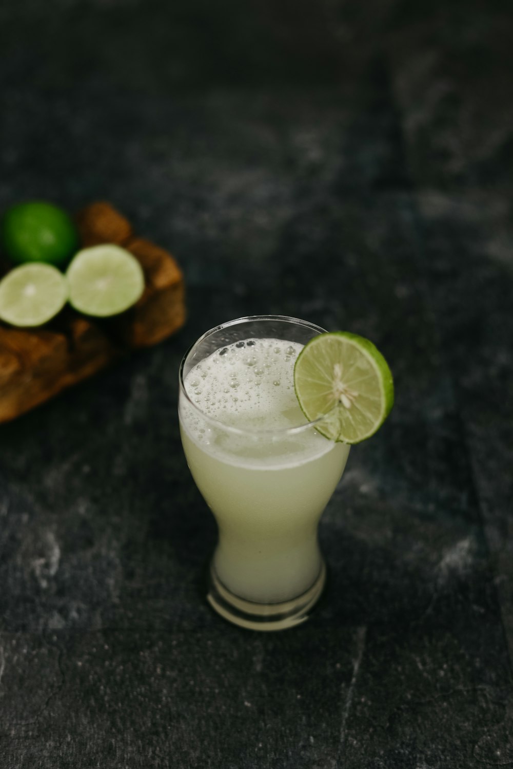 clear drinking glass with white liquid and sliced lemon