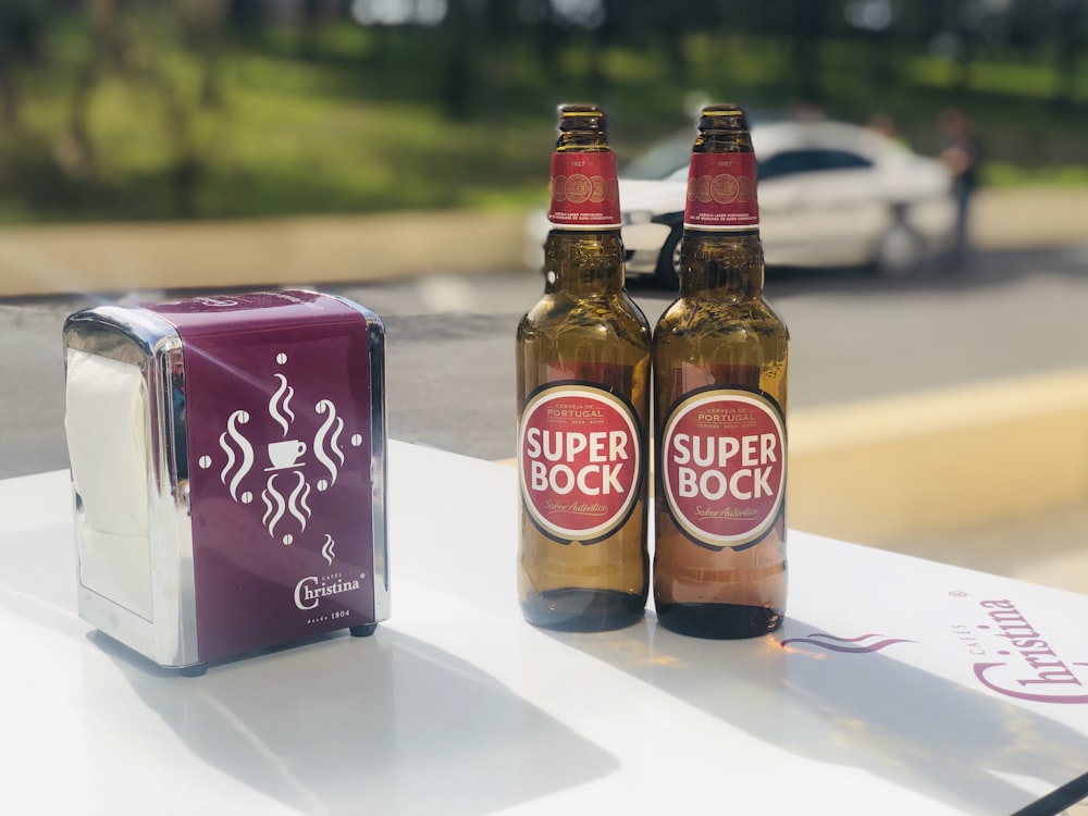 two brown glass bottles on white table