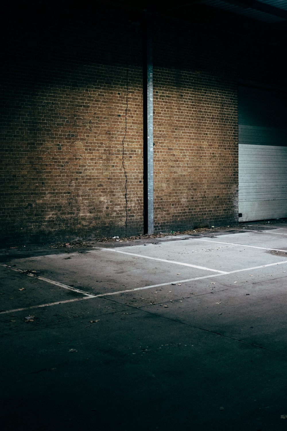 brown brick wall beside gray concrete road